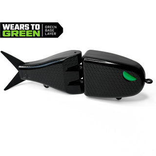 Black Maxed Fishing Raptor glide bait with green eye and textured scale pattern. Badge in left corner that says "wears to green. Green base layer."