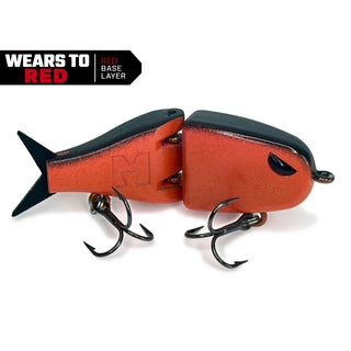 A two-piece fishing lure shown on a white background with a black and red graphic banner in the top left corner. The lure features a metallic red-orange body with a black top and a black tail, equipped with two treble hooks.