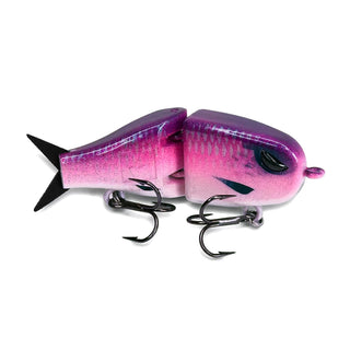 Handmade Maxed Fishing Raptor BFS glide bait in a custom pink and purple colorway with silver scale detailing, metallic purple topcoat, translucent pink belly, and black treble hooks on a white background.