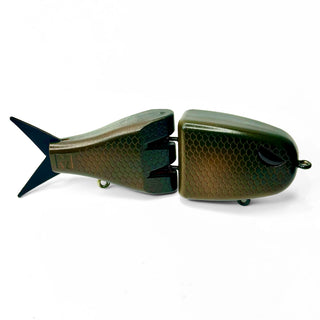 A two-piece jointed fishing lure shaped like a fish, featuring a dark olive green camo patterned body with a black tail, shown on a plain white background.