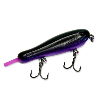 A BFS topwater fishing lure with a black and purple gradient body, a bright purple tail, and two treble hooks, shown on a plain white background.