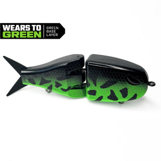 A two-piece fishing lure shown on a white background with a 'WEARS TO GREEN' badge in the top left corner. The lure features a black top with a green gradient and black spots on the bottom, designed to look similar to a crappie.