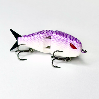 A purple and white snake skin raptor fishing lure with a shiny finish and VMC hooks.