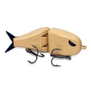 A tan handmade BFS fishing lure with a black tail, black eye detail, and two black treble hooks, shown on a plain white background.
