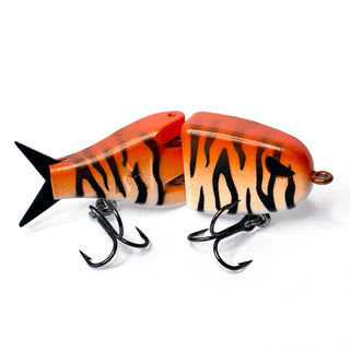 A two-piece hard bait fishing lure with a tiger-stripe pattern in orange, black, and white.