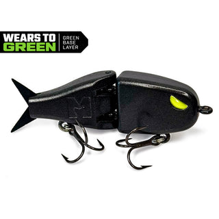 A metallic or glitter black BFS glide bait with a bright yellow-green eye and two treble hooks, shown on a white background with a black and green 'WEARS TO GREEN GREEN BASE LAYER' badge in the top-left corner.